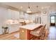 Modern kitchen featuring white cabinets, stainless steel appliances, and an island with bar seating at 1030 Little Cowgirl Ln, Cleveland, NC 27013
