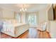 Comfortable main bedroom with wood floors, natural light, and stylish decor at 1030 Little Cowgirl Ln, Cleveland, NC 27013