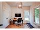 Bright home office featuring wood floors, a modern desk, and a charming rustic chandelier at 1030 Little Cowgirl Ln, Cleveland, NC 27013