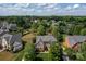 Aerial view of a charming home nestled among mature trees in a tranquil neighborhood at 1116 Crooked River Dr, Waxhaw, NC 28173