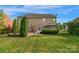 Spacious backyard featuring a well-maintained lawn, patio area, and lush greenery, perfect for outdoor entertaining at 1116 Crooked River Dr, Waxhaw, NC 28173