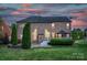 The brick home's backyard boasts a fire pit, patio dining, tall privacy trees and a cozy gazebo at 1116 Crooked River Dr, Waxhaw, NC 28173