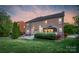 Back exterior view with brick, patio, gazebo, and lush green lawn at 1116 Crooked River Dr, Waxhaw, NC 28173
