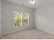 Bedroom with neutral carpet and two large windows, providing ample natural light at 1116 Crooked River Dr, Waxhaw, NC 28173