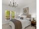 Cozy bedroom with natural light and a decorative chandelier above the bed at 1116 Crooked River Dr, Waxhaw, NC 28173