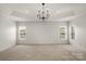 Spacious bonus room with neutral carpet and tray ceiling at 1116 Crooked River Dr, Waxhaw, NC 28173