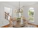 Sunlit dining area with views, showcasing the wooden table, chairs, and light fixture at 1116 Crooked River Dr, Waxhaw, NC 28173