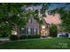 Lovely brick home with a well-kept lawn and classic architectural details under a scenic sky at 1116 Crooked River Dr, Waxhaw, NC 28173