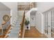 Grand foyer featuring hardwood floors, staircase with decorative iron railings, and a welcoming atmosphere at 1116 Crooked River Dr, Waxhaw, NC 28173