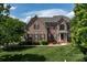 Charming two-story brick home with a well-manicured lawn at 1116 Crooked River Dr, Waxhaw, NC 28173