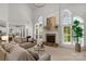 Inviting living room with large windows, a cozy fireplace, and stylish furnishings at 1116 Crooked River Dr, Waxhaw, NC 28173