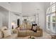 Bright, open living room flows into a gourmet kitchen with white cabinets and stainless steel appliances at 1116 Crooked River Dr, Waxhaw, NC 28173