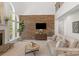 Elegant living room featuring a stone accent wall, fireplace, and high ceilings at 1116 Crooked River Dr, Waxhaw, NC 28173