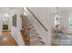 Elegant staircase with carpeted steps and decorative metal railings at 1116 Crooked River Dr, Waxhaw, NC 28173