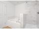 Elegant bathroom showcases a separate tub and shower with marble tile surround at 1148 Thayer Glen Ct, Charlotte, NC 28213