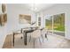 Bright dining area featuring neutral decor, a modern table, and sliding doors to the backyard at 1148 Thayer Glen Ct, Charlotte, NC 28213