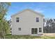 Rear view showcasing vinyl exterior, patio area, lawn, and mature trees at 1148 Thayer Glen Ct, Charlotte, NC 28213