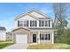 Charming two-story home with a brick facade and a well-manicured lawn on a sunny day at 1148 Thayer Glen Ct, Charlotte, NC 28213