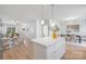 Open kitchen with white cabinets and a kitchen island overlooking a living and dining area at 1148 Thayer Glen Ct, Charlotte, NC 28213