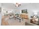 Open-concept living room featuring lots of natural light, an entertainment center, and neutral decor at 1148 Thayer Glen Ct, Charlotte, NC 28213