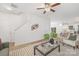 Bright living room featuring a ceiling fan, modern decor, and an open floor plan to the kitchen at 1148 Thayer Glen Ct, Charlotte, NC 28213