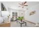 Bright living room with a ceiling fan, modern decor, and a view of the staircase at 1148 Thayer Glen Ct, Charlotte, NC 28213