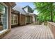 An expansive wooden deck looks out over a lush backyard at 1200 Churchill Downs Dr, Waxhaw, NC 28173
