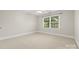 Neutral bedroom with carpet, a ceiling fan, one window, and base trim at 1200 Churchill Downs Dr, Waxhaw, NC 28173