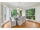 Sunlit dining area featuring large windows, hardwood floors, and modern decor at 1200 Churchill Downs Dr, Waxhaw, NC 28173