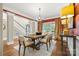 Charming dining room with a modern chandelier, large windows, and hardwood floors at 1200 Churchill Downs Dr, Waxhaw, NC 28173