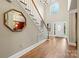 Elegant foyer with hardwood floors, staircase, chandelier, and natural light at 1200 Churchill Downs Dr, Waxhaw, NC 28173