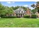 Charming brick home with manicured lawn, lush landscaping and detailed architectural features at 1200 Churchill Downs Dr, Waxhaw, NC 28173