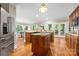 Modern kitchen island with marble countertop, stainless steel appliances, and hardwood floors at 1200 Churchill Downs Dr, Waxhaw, NC 28173