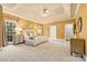 Spacious main bedroom features tray ceiling, large windows, sitting area, neutral carpet, and en-suite bathroom at 1200 Churchill Downs Dr, Waxhaw, NC 28173
