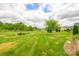 Expansive backyard with lush green grass and mature trees at 121 Martingale Ave, Mooresville, NC 28115