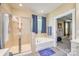 Well-lit bathroom with a separate shower, soaking tub, and blue accent decor at 121 Martingale Ave, Mooresville, NC 28115