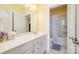 Well-lit bathroom featuring a large mirror, a vanity with drawers, and an adjacent toilet and shower area at 121 Martingale Ave, Mooresville, NC 28115