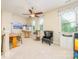 Bright bonus room features chair, artist's easel, ceiling fan, and large windows for natural light at 121 Martingale Ave, Mooresville, NC 28115