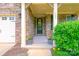Inviting front porch with stone accents, space for seating and a beautiful entry door at 121 Martingale Ave, Mooresville, NC 28115