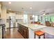 Open kitchen with stainless steel appliances, granite countertops and a large island at 121 Martingale Ave, Mooresville, NC 28115