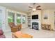 Bright living room featuring a fireplace, built-in shelving, and expansive windows at 121 Martingale Ave, Mooresville, NC 28115