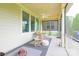 Comfortable screened porch with a ceiling fan, cozy bench seating, and a view of the serene backyard at 121 Martingale Ave, Mooresville, NC 28115