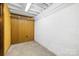 Unfinished basement with concrete flooring, wood paneling, and white brick wall at 137 Deal Ln, Statesville, NC 28677