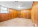 Unfinished basement with wood paneling, window, and concrete flooring at 137 Deal Ln, Statesville, NC 28677