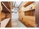 Unfinished basement with wooden shelves, concrete floors, and painted white brick walls at 137 Deal Ln, Statesville, NC 28677