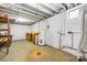 Spacious unfinished basement with a water heater, wooden desk, and painted white brick walls at 137 Deal Ln, Statesville, NC 28677