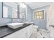 Bathroom featuring dual square vessel sinks on a dark countertop, complemented by marble-patterned tile flooring at 137 Deal Ln, Statesville, NC 28677