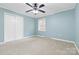 Cozy bedroom showcasing soft carpeting, a ceiling fan, and a closet, offering comfort and functionality at 137 Deal Ln, Statesville, NC 28677