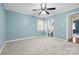 Light-filled bedroom painted in a soothing blue hue, features plush carpeting and a ceiling fan at 137 Deal Ln, Statesville, NC 28677