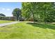 Brick ranch-style house with a well-manicured lawn and mature trees at 137 Deal Ln, Statesville, NC 28677